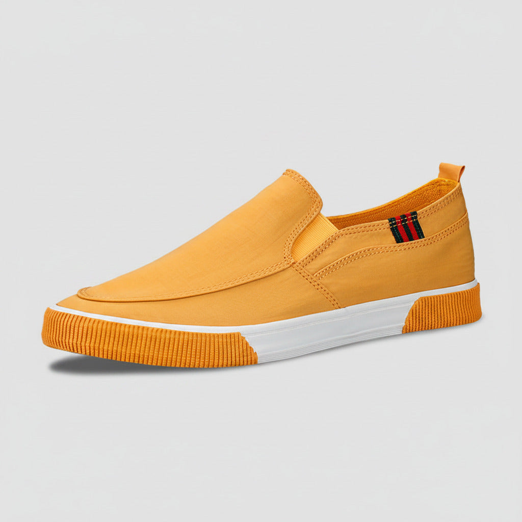 Yellow slip-on sneaker with a white sole on a white background