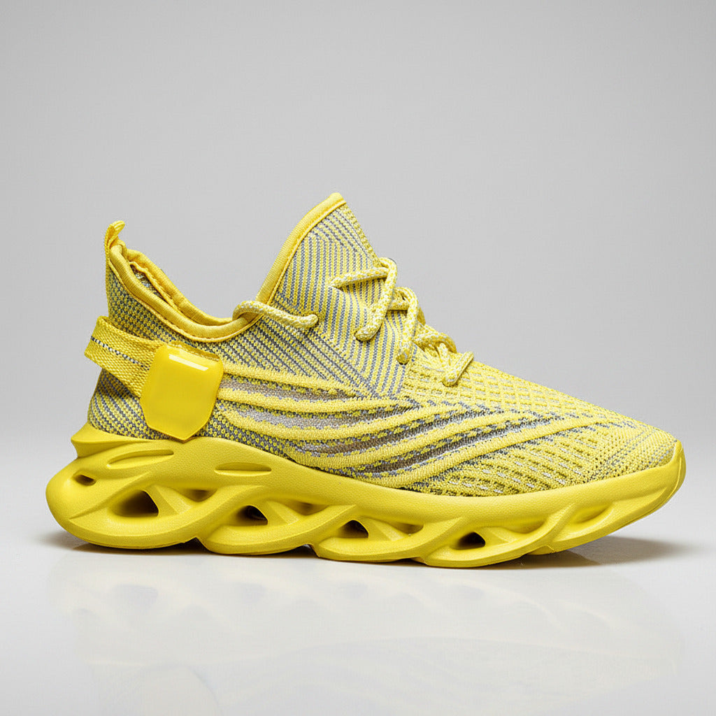 Yellow sneaker with unique sole design on a white background