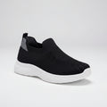 Black slip-on sneaker with white sole on a white background