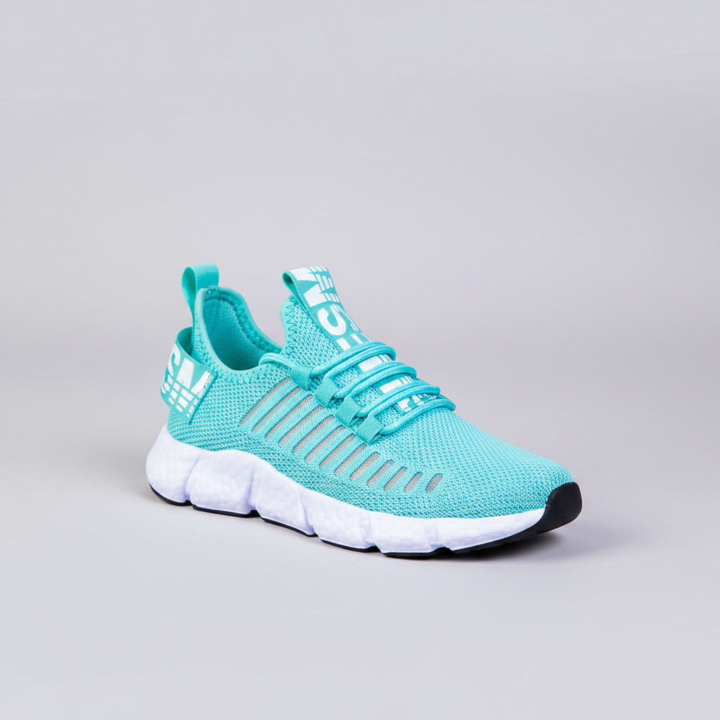 Turquoise running shoes with white soles on a wooden floor