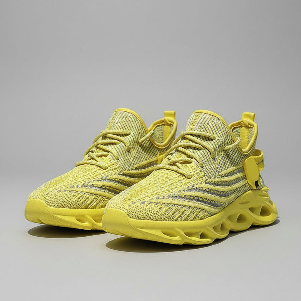 Yellow sneakers being held up against a blue background