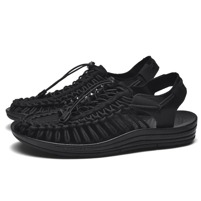Black sandals with woven design on a white background