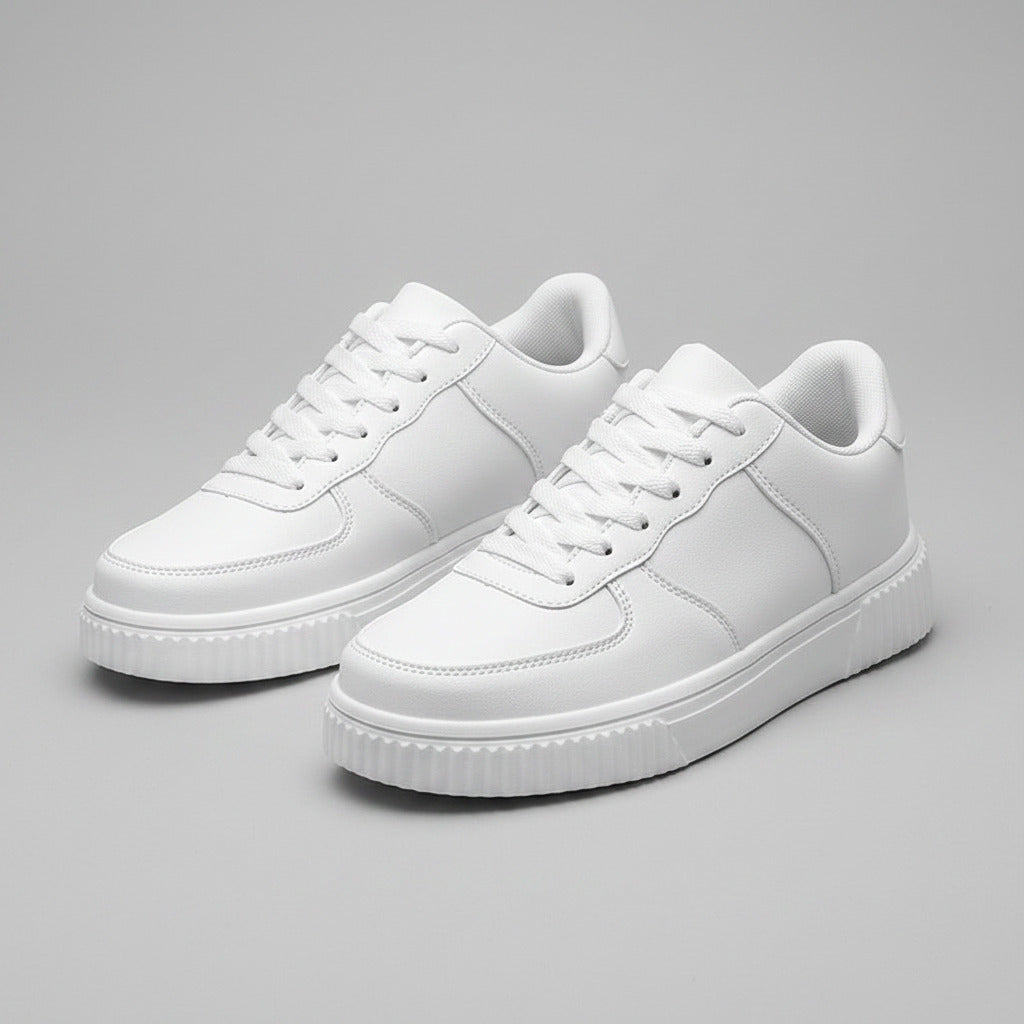White sneakers on a gray surface with a blurred background
