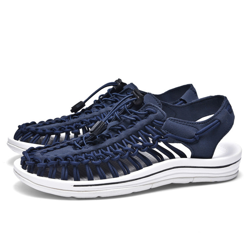 Navy blue sandals with white sole on a white background