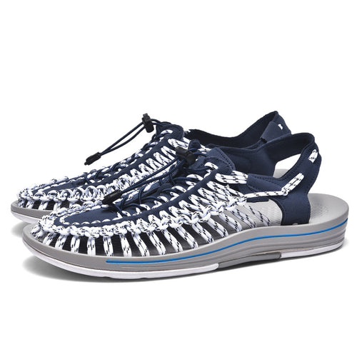 Navy and white sandals with a gray sole on a white background