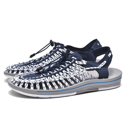 Navy and white sandals with a gray sole on a white background