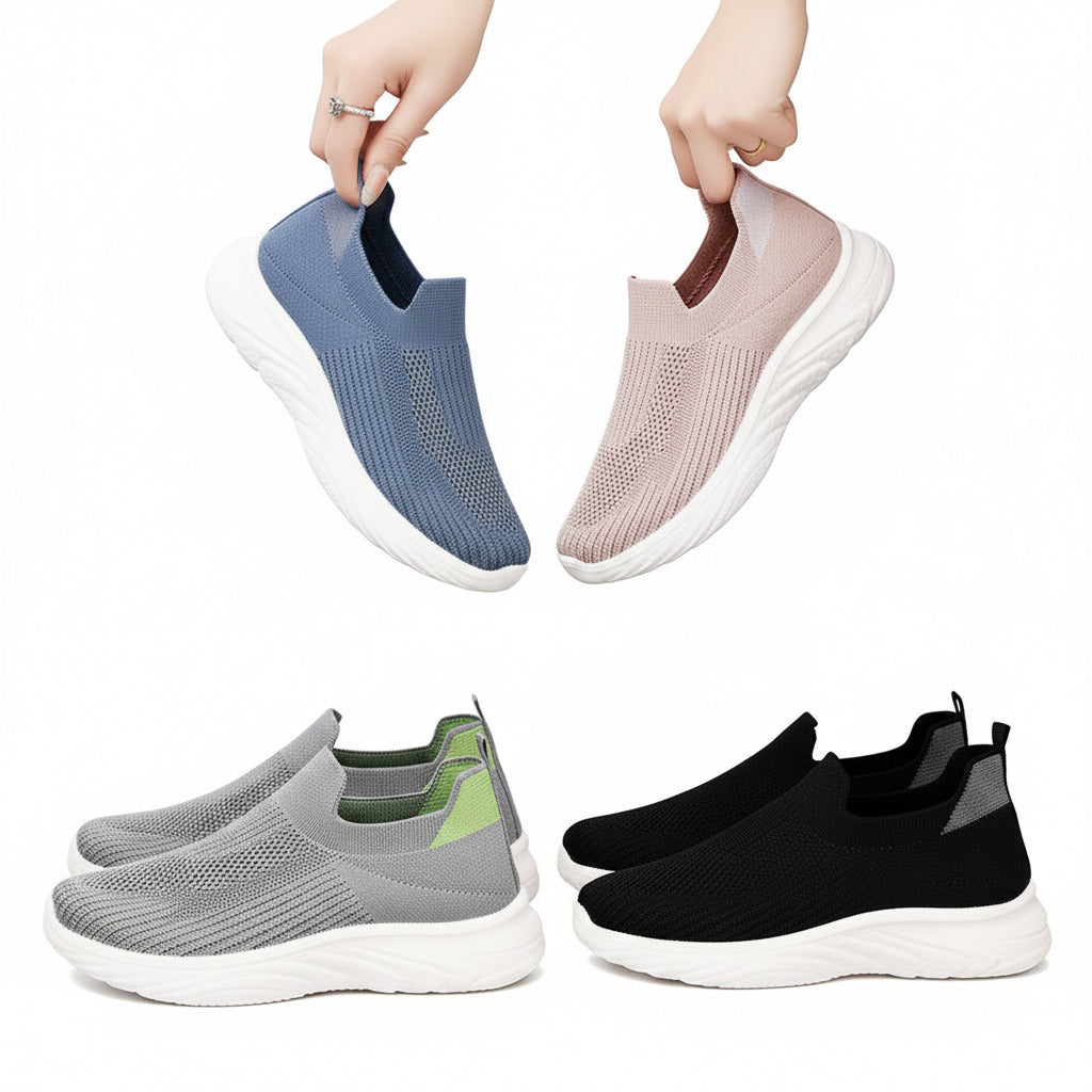 Person holding two slip-on shoes with a focus on different color options.