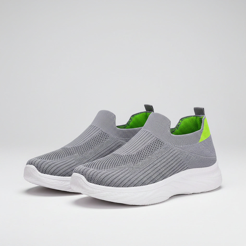 Gray slip-on sneaker with a white sole on a white background