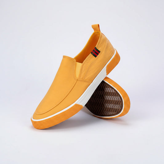 Yellow slip-on shoes with white soles on a gray background