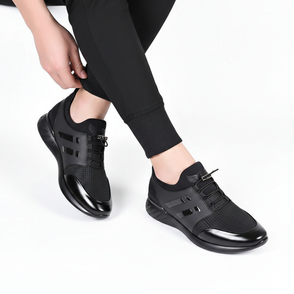 Person wearing black athletic shoes on a gray floor.