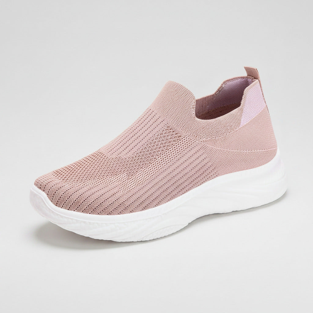 Pink slip-on sneaker with white sole on a white background